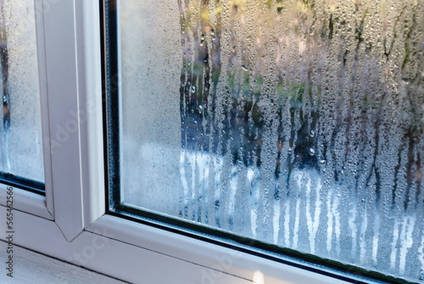 Obraz Drops of condensation on the metal-plastic window. Fragment of a plastic window with water condensation on the glass, temperature difference, cooling, humidity in the room. 