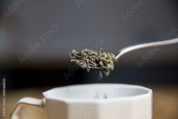 Fototapeta adding green tea to the cup