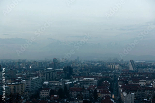 Obraz City covered in snow with the mountains in the background