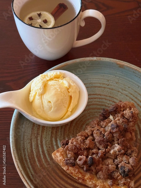 Fototapeta Apple Crumble Dessert with vanilla ice cream on Rustic Wooden Surface