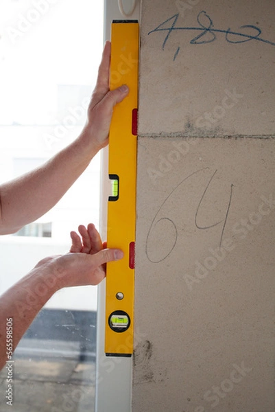 Obraz hand holding level, on a constuction Site 