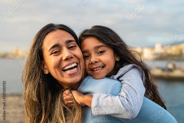 Obraz Happy Latin mother enjoying time with her child on the beach - Family and love concept