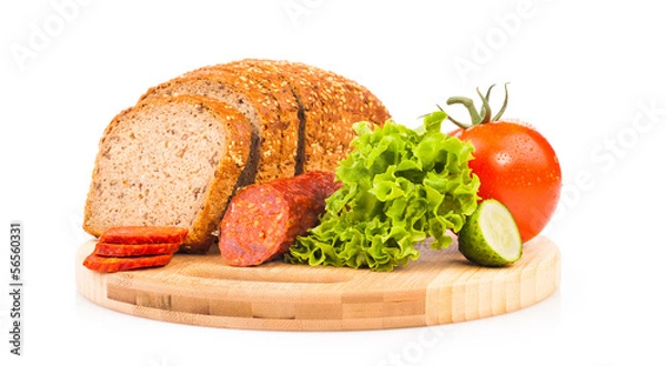 Fototapeta bread and smoked sausages on wooden plate isolated on white