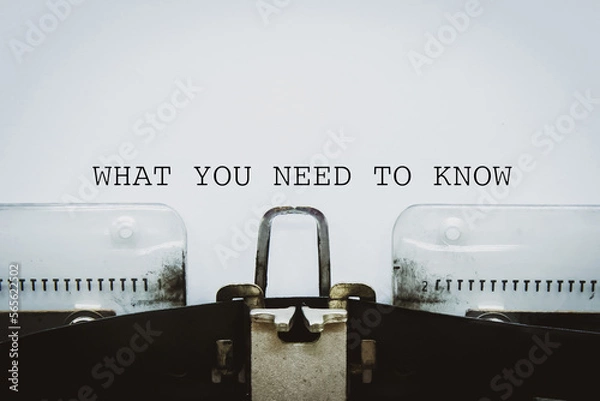 Fototapeta What You Need To Know text typed on a vintage typewriter.