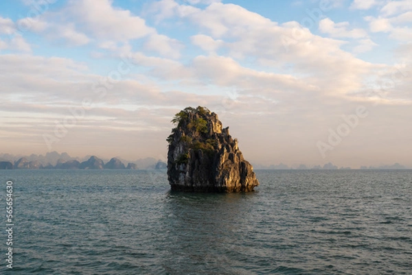 Fototapeta A lone islet during sunrise in Bai Tu Long bay