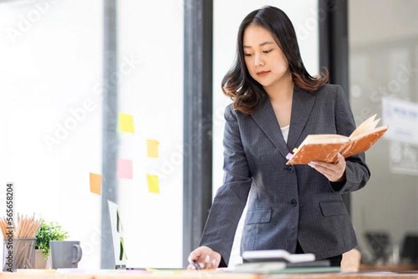 Obraz Business Documents, Auditor business Asian woman checking searching document legal prepare paperwork or report for analysis TAX time,accountant Documents data contract partner deal in workplace office