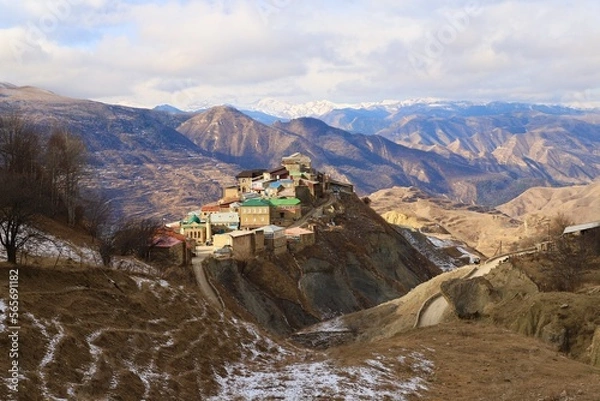 Fototapeta The bright and colorful village of Chokh against the backdrop of a mountain panorama in the Gunibsky district of Dagestan.