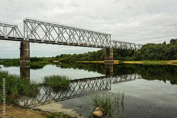 Fototapeta Several sections of the railway bridge are laid over the river bed