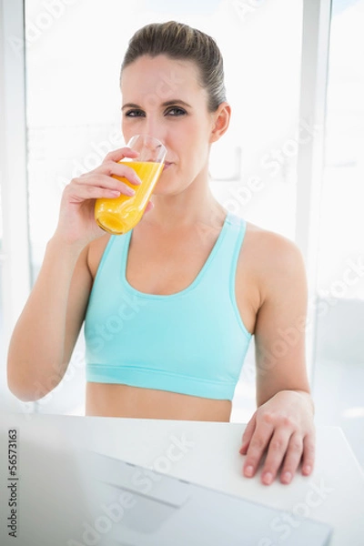 Obraz Woman wearing sportswear drinking orange juice