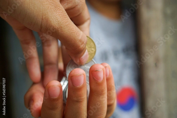 Fototapeta Stock photo of someone who is making a monetary donation