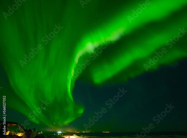 Obraz Very bright green with shades of blue Northern lights that everyone had the chance to admire in Iceland in January this year. Experienced locals take tourists on a hunt for the magical aurora borealis