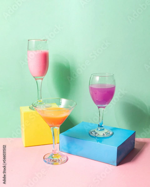 Fototapeta Colorful cocktails on pastel light pink and green background. Creative drink concept. Minimalistic beverage composition.