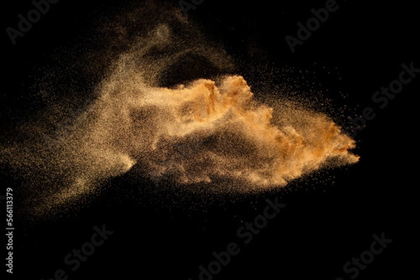 Obraz Dry river sand explosion. Brown colored sand splash against  black background.