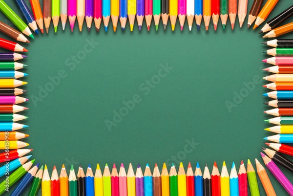 Fototapeta wreath of multicolored pencils on green chalkboard background, top view, copy space, back to school concept