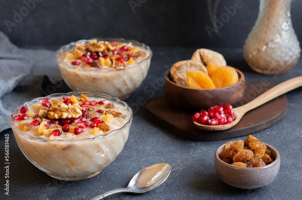 Fototapeta Traditional Turkish delicious mixed dessert, ashura (asure) with pomegranate seeds, walnut, apricot, Noah’s pudding