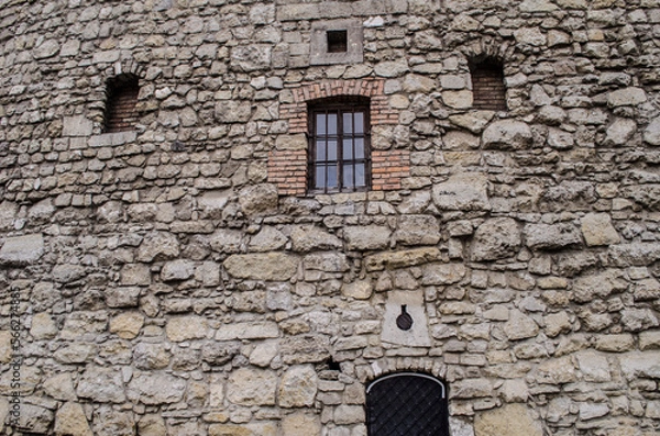 Fototapeta Old stone wall with doors and windows of the Powder Tower in the center of Lviv.