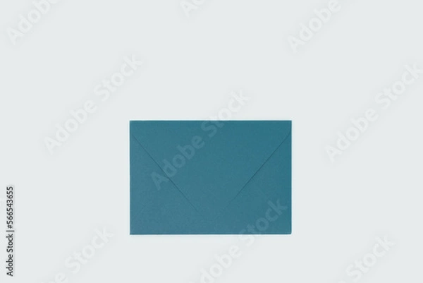 Obraz Green envelope on a blue background. Selective focus.