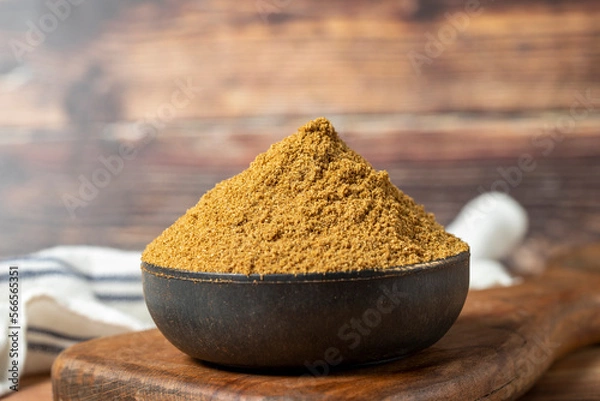 Fototapeta Powdered cumin spice. Cumin spice in bowl on wooden background. Dry spice concept. close up