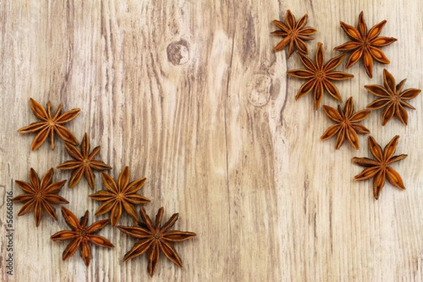 Fototapeta Star anise on wooden surface with copy space