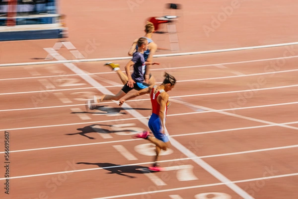 Obraz rivalry at finish line sprint race motion blur