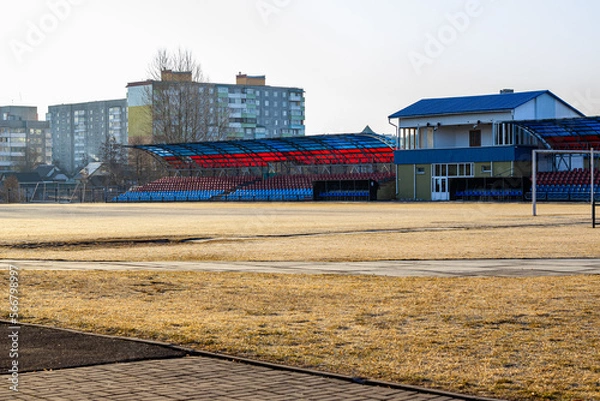 Fototapeta city small football stadium. organization of public space. Public amphitheater, empty seats in Smorgon, Belarus