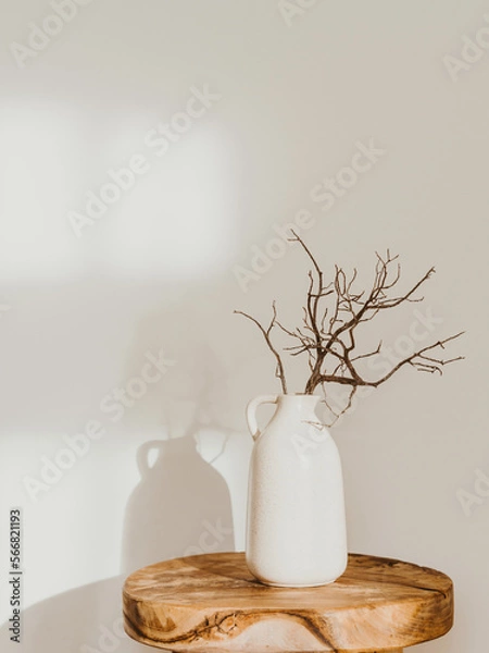 Fototapeta Modern minimalist style interior with ceramic vase with branch on wood table