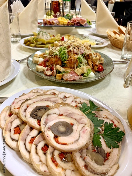 Fototapeta table setting with appetizers, plates, glasses