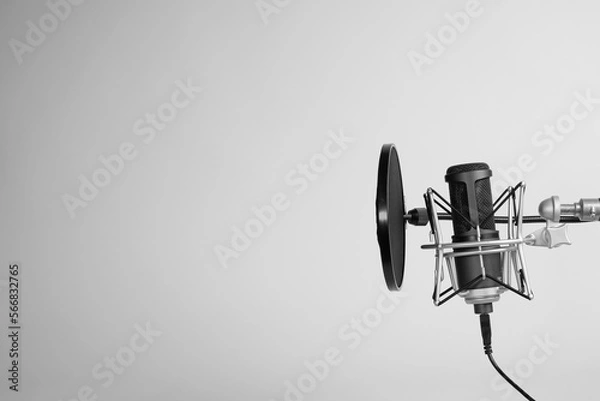 Fototapeta a microphone on gray background with copy space. podcasting background. 