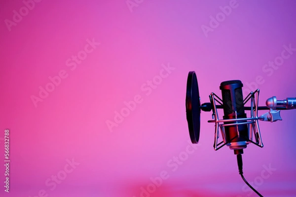 Fototapeta black microphone on pink and purple neon background with copy space.
