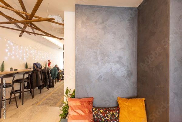 Fototapeta Corner of a cafe bar with bench with cushions