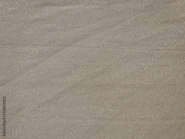 Fototapeta Thin light brown textured fabric slightly wrinkled stretched with its thread fibers