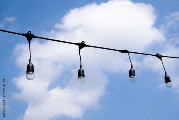 Obraz Clear string lights on blue sky background