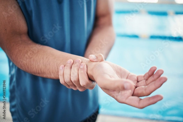 Fototapeta Pain in wrist, sports and man by swimming pool with injury, muscle ache and arthritis inflammation. Wellness, medical care and hands of male with accident or bruise from fitness, exercise or training