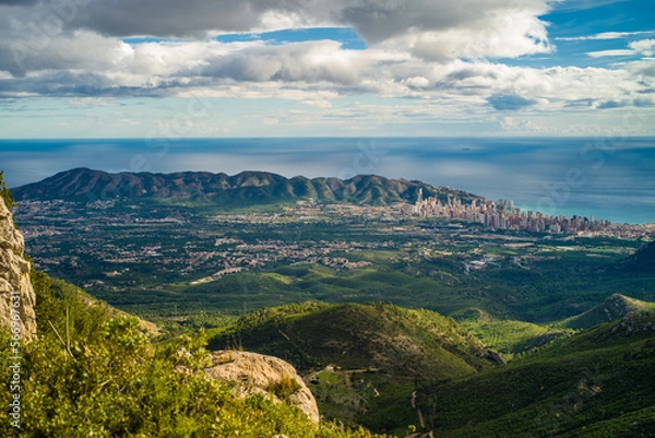 Fototapeta view from Mount Bernia on the trees and valley and apartment buildings of the city of Benidorm and Serra Gelada