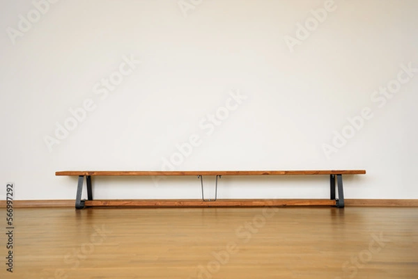 Fototapeta Wooden bench standing on floor in empty sport gymnasium hall.