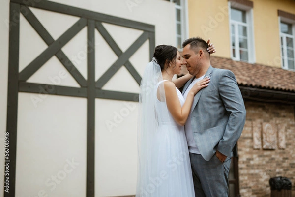 Fototapeta young couple the groom in and the bride on a walk