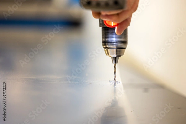 Fototapeta Drilling in a metal sheet
