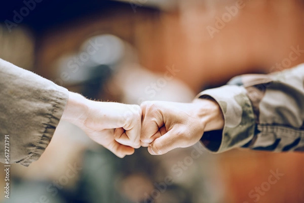 Fototapeta Hands, soldier and fist bump for partnership, deal or agreement in collaboration or trust together. Hand of army people touching fists in support for friendship, community or unity in solidarity
