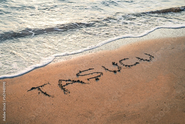 Fototapeta Taşucu beach written on the beach sand near mediterranean sea