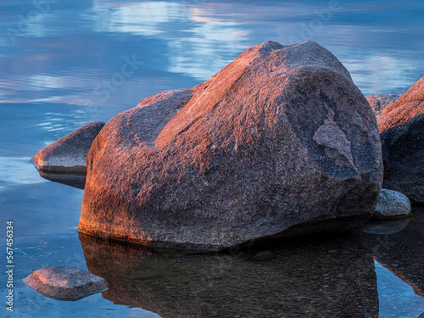 Obraz large boulders in a lake at sunrise