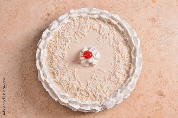 Fototapeta a cake with a strawberry on top of it is sitting on the table