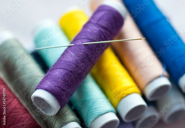 Obraz New spools of colourful thread with sewing needle