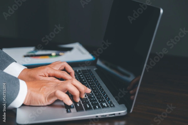 Fototapeta Businesswoman hand typing laptop computer keyboard with virtual screen, modern background concept, can put your text with icon bundle, copy space