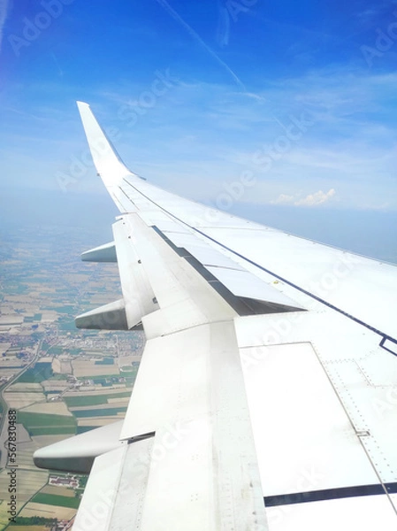 Fototapeta View from the plane. View from a landing airplane out the window of city at sunset