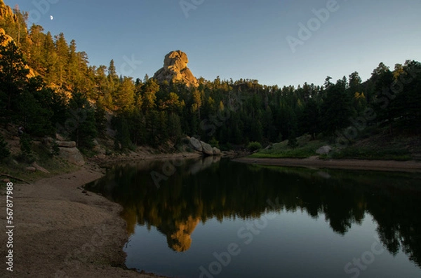 Obraz Unique rock formation reflected in calm river water at dusk