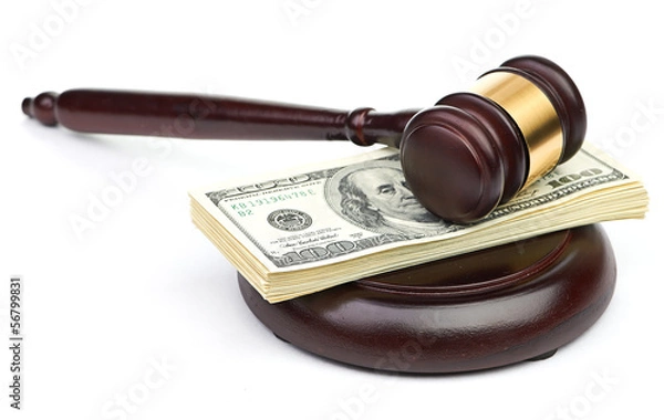 Fototapeta Law gavel on a stack of American money.