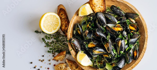 Fototapeta fragrant boiled mussels in herb and cream sauce