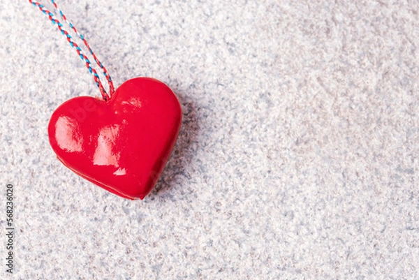 Fototapeta Red toy heart on granite stone textured background. Valentines day concept. Top view, flat lay, copy space