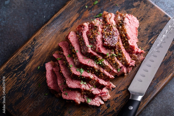 Fototapeta Corned beef cooked and sliced on a cutting board