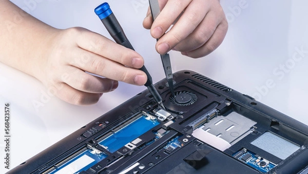 Obraz Technician fixing computer. Repair and upgrade concept of laptop. Workshop background
